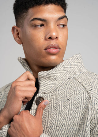 Man wearing a textured coat with a gray background