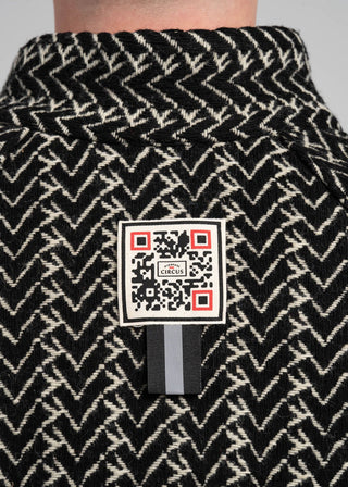 Black and white patterned fabric with a QR code label on a gray background