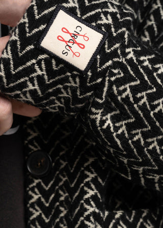 Close-up of a black and white patterned fabric with a brand label.