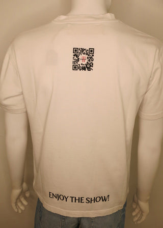 A mannequin wearing a white short-sleeve T-shirt from the back, with a small black QR code graphic near the upper back and the text 'ENJOY THE SHOW!' printed near the lower back. The mannequin is also wearing light blue jeans against a plain beige background.