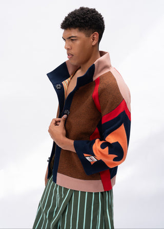 Person wearing a multi-color jacket with a white background