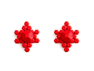Red snowflake-shaped earrings on a white background