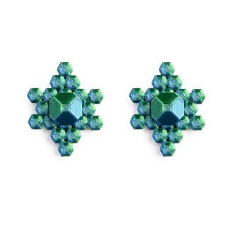 Pair of green and blue crystal snowflake earrings on a white background
