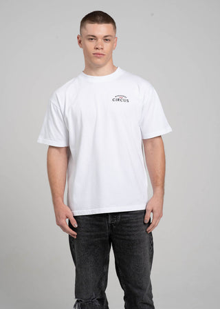 Person wearing a white t-shirt with text on a plain background