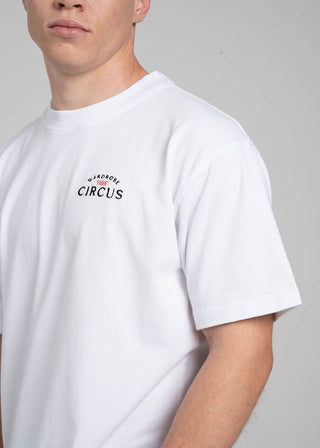 Person wearing a white t-shirt with text on a plain background