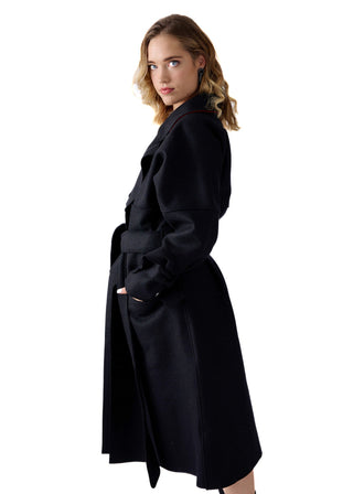A woman modeling a long black wool coat with a matching waist belt, shown from a three-quarter back view against a solid white background.