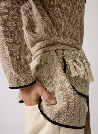 Unisex artist jacket in premium cotton with a bold beige diamond design and black finished edges.