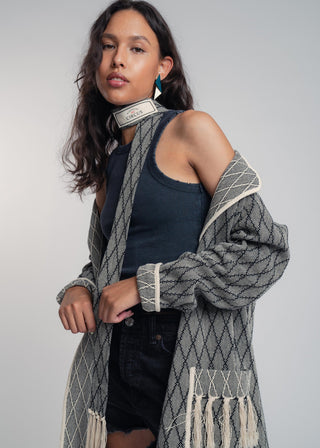 Unisex artist jacket in premium cotton with a bold black diamond design and ecru finished edges.