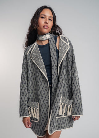 Unisex artist jacket in premium cotton with a bold black diamond design and ecru finished edges.