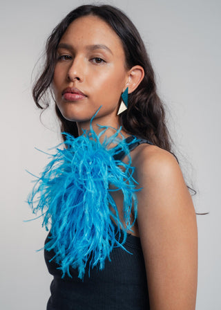 Unisex ostrich feather brooch accessory with a bold dark turkis design.