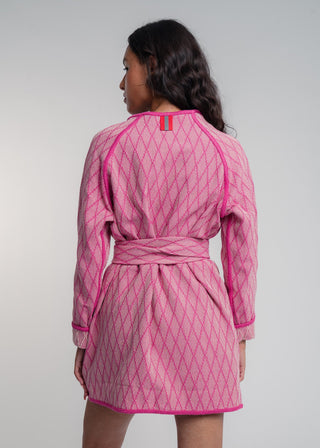 Unisex artist jacket in premium cotton with a bold fuchsia diamond design and pink finished edges.