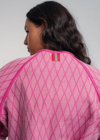 Unisex artist jacket in premium cotton with a bold fuchsia diamond design and pink finished edges.