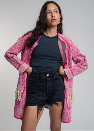 Unisex artist jacket in premium cotton with a bold fuchsia diamond design and pink finished edges.