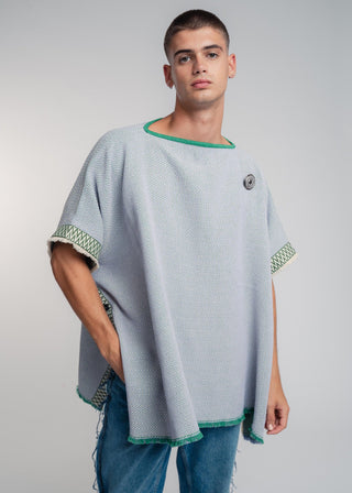 Unisex reversible poncho in premium cotton with a bold flag green and lilac duo-color design, featuring a bold statement button.