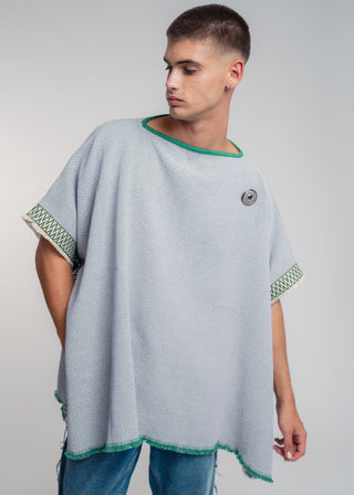 Unisex reversible poncho in premium cotton with a bold flag green and lilac duo-color design, featuring a bold statement button.