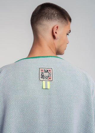 Unisex reversible poncho in premium cotton with a bold flag green and lilac duo-color design, featuring a bold statement button.