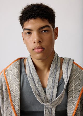 Unisex artist jacket in premium cotton with a bold grey diamond design and orange finished edges.