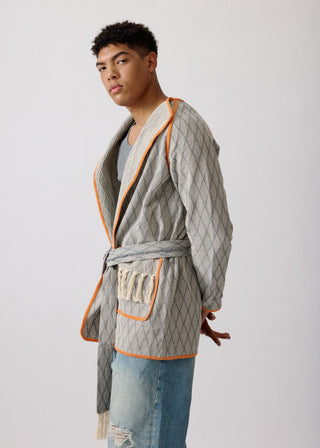 Unisex artist jacket in premium cotton with a bold grey diamond design and orange finished edges.