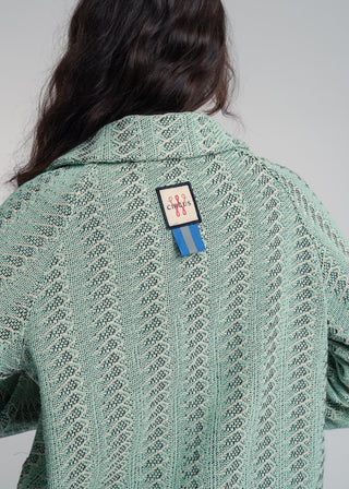 Back view of a unisex short jacket in premium cotton with a bold mint and navy duo-color design, featuring interchangeable buttons for a customizable look.