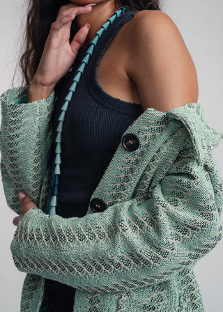 Side view of a unisex short jacket in premium cotton with a bold mint and navy duo-color design, featuring interchangeable buttons for a customizable look.