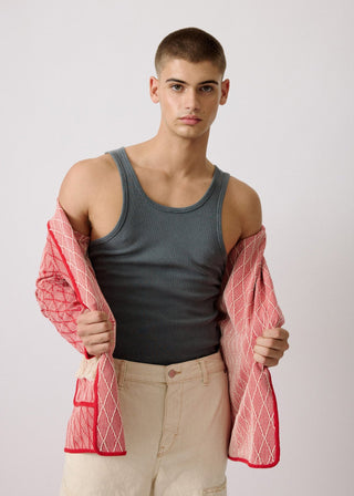 Unisex artist jacket in premium cotton with a bold red diamond design and red finished edges.